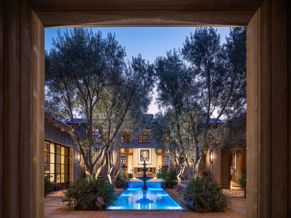 statement lighting in the large fountain and landscape of this open courtyard of a custom home in Napa, CA